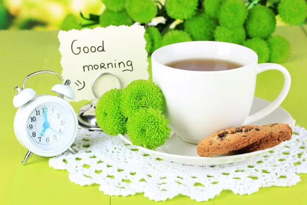 Beautiful green chrysanthemum with cup of tea on table close-up — Stock Photo, Image