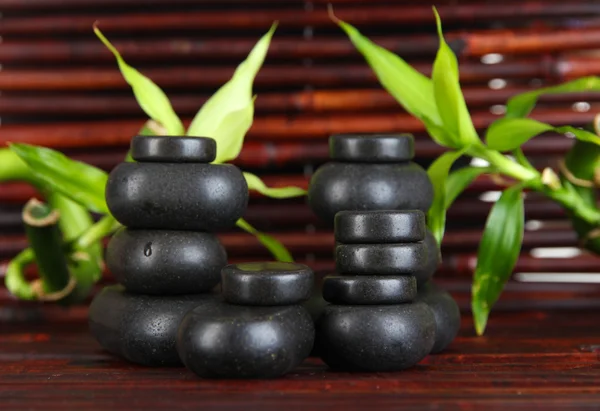 Spa stones and bamboo on bamboo mat background — Stock Photo, Image