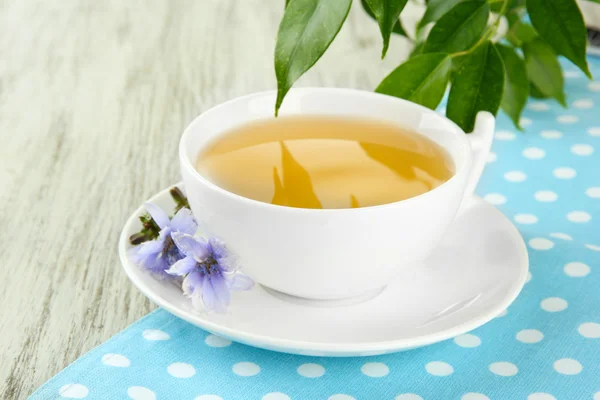 Cup of tea with chicory, on wooden background — Stock Photo, Image