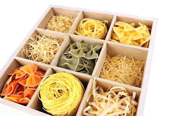 Nio sorters pasta i trälåda sektioner närbild isolerad på vit — Stockfoto