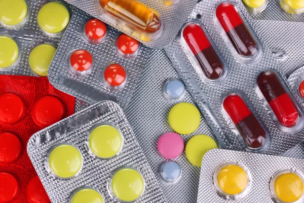 Capsules and pills packed in blisters close-up background — Stock Photo, Image