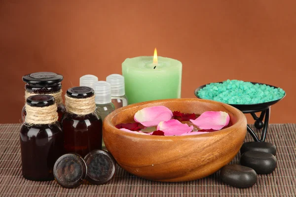 Spa composition with aroma oils on brown background — Stock Photo, Image