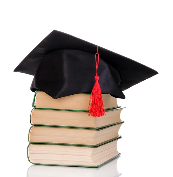Grad hat with books isolated on white — Stock Photo, Image