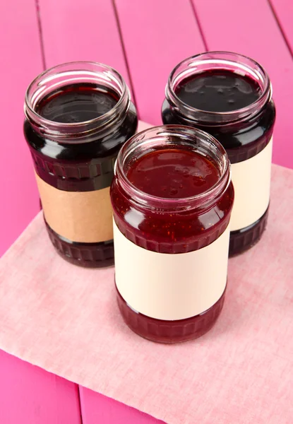 Tasty jam in banks on table — Stock Photo, Image