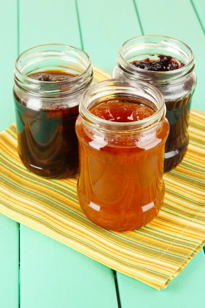 Tasty jam in banks on table — Stock Photo, Image