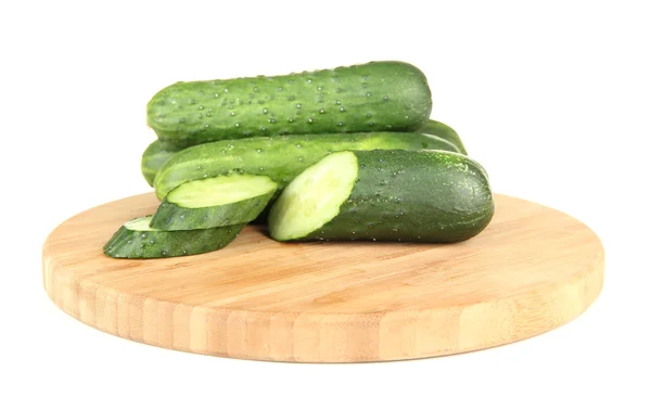 Tasty green cucumbers on wooden cutting board, isolated on white — Stock Photo, Image