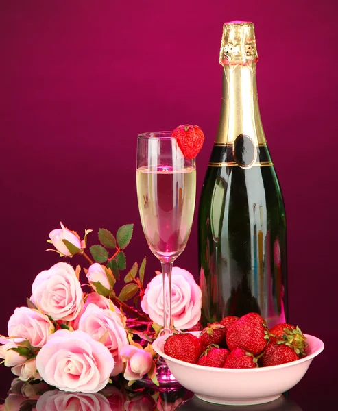 Romantic still life with champagne, strawberry and pink roses, on dark color background — Stock Photo, Image