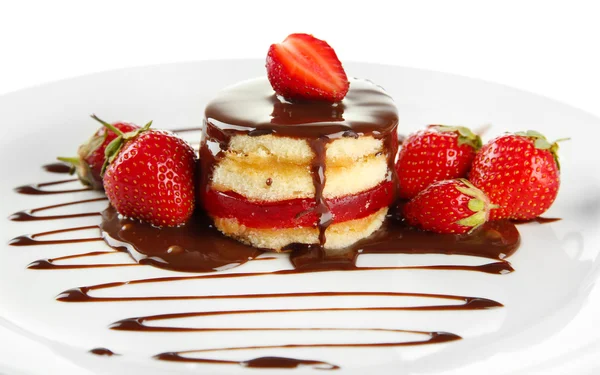 Tasty biscuit cake with chocolate and berries on plate, isolated on white — Stock Photo, Image