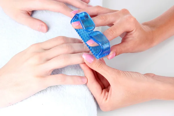 Man doing manicure in salon