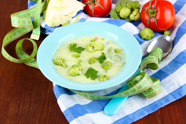 Cabbage soup in plates on napkin on wooden table — Stock Photo, Image