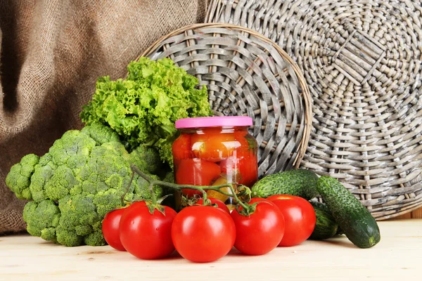 Fresh vegetables and canned on wooden table close up — Stock Photo, Image