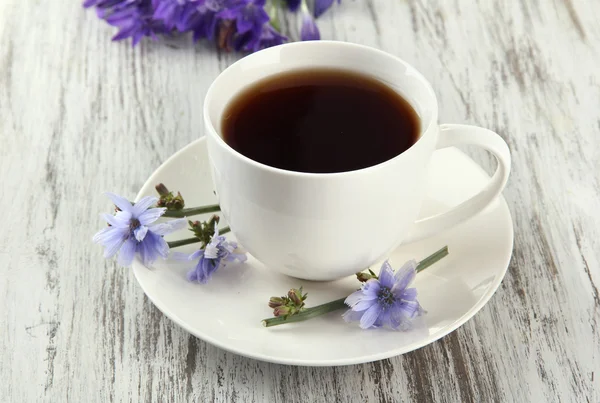 Šálek čaje s čekankou, na dřevěné pozadí — Stock fotografie