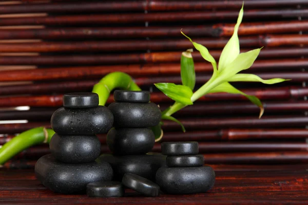 Spa stones and bamboo on bamboo mat background — Stock Photo, Image