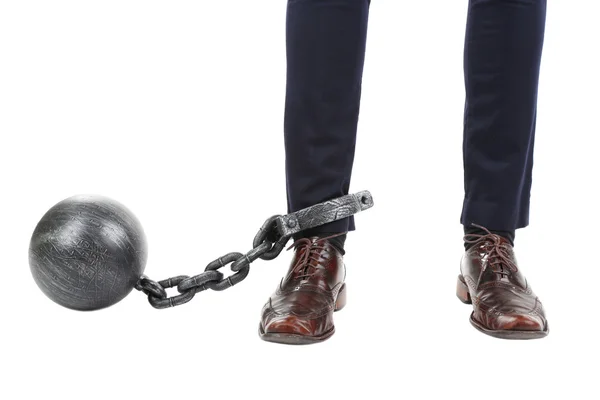 Empresario con bola y cadena unidas al pie aisladas sobre blanco — Foto de Stock