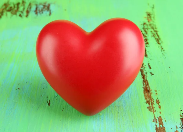 Decorative red heart on color wooden background — ストック写真