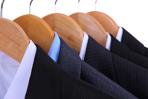 Suits with shirts on hangers on white background — Stock Photo, Image