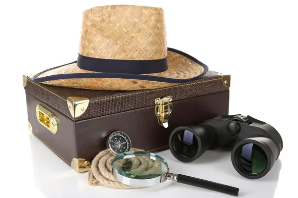 Black modern binoculars with suitcase and straw hat isolated on white — Stock Photo, Image