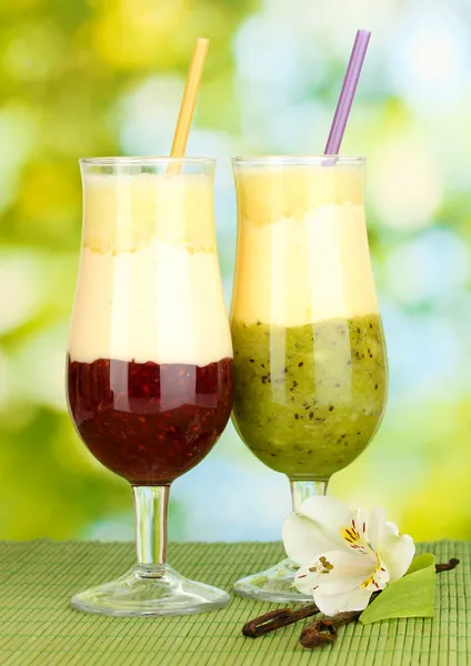 Delicious fruit smoothies on bright background — Stock Photo, Image