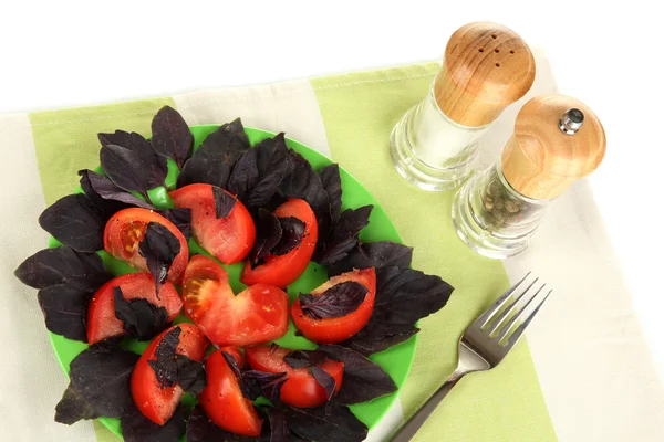 Salad of fresh tomatoes with basil leaves on napkin isolated on white — Stock Photo, Image