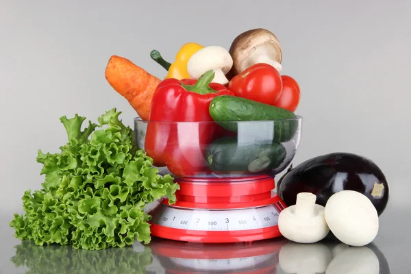 Fresh vegetables in scales on gray background — Stock Photo, Image