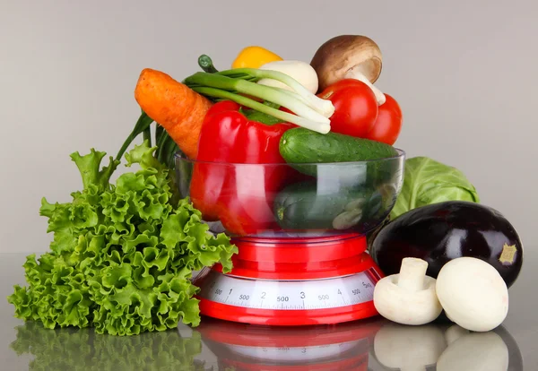 Fresh vegetables in scales on gray background — Stock Photo, Image