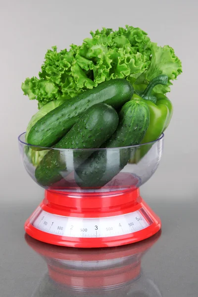 Fresh vegetables in scales on gray background — Stock Photo, Image