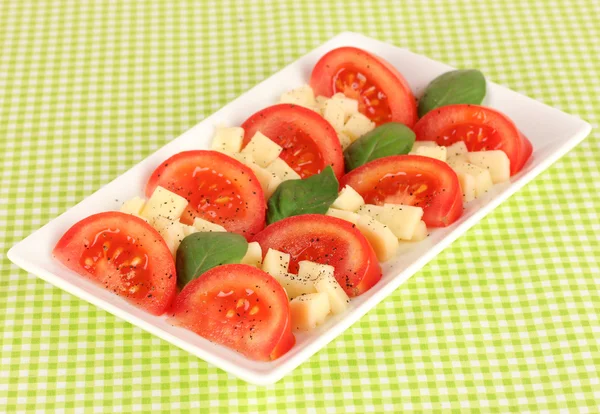 Cheese mozzarella with vegetables in plate on table — Stock Photo, Image