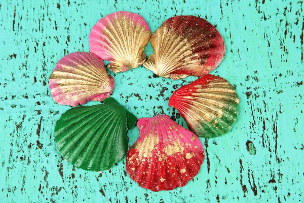 Colorful seashells on color wooden background — Stock Photo, Image