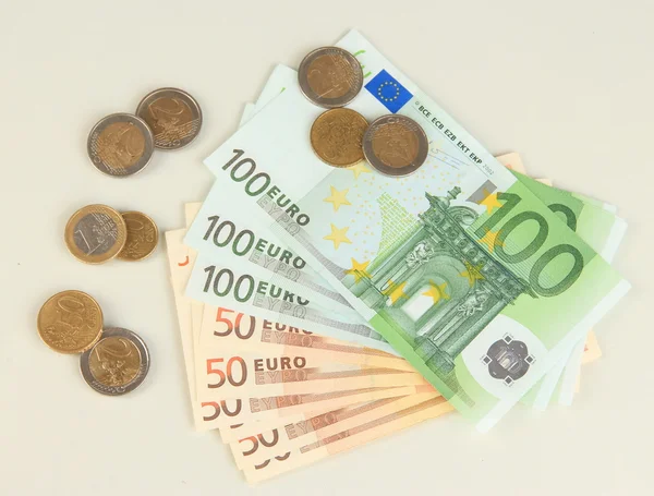 Euro banknotes and euro cents isolated on white — Stock Photo, Image