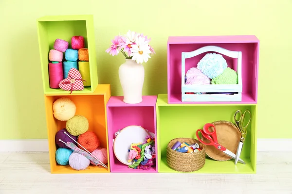 Colorful shelves of different colors with utensils on wall background — Stock Photo, Image