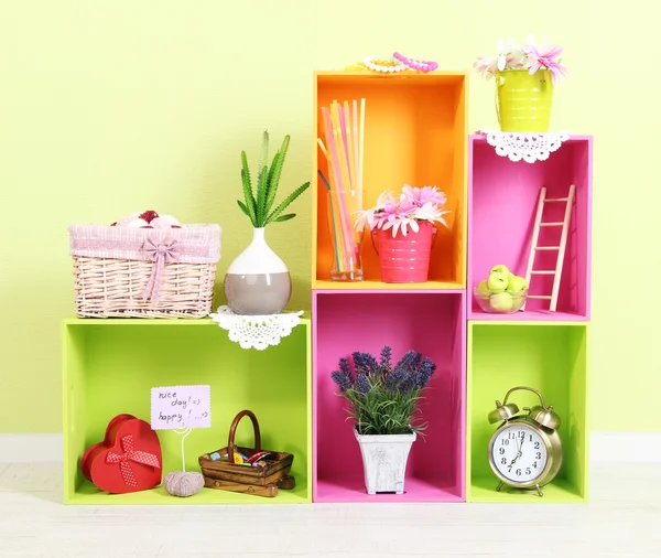 Shelves of different bright colors with decorative addition on wall background — Stock Photo, Image