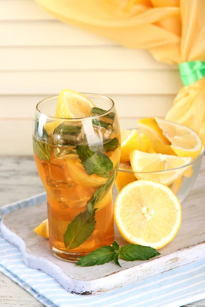 Té helado con limón y menta sobre mesa de madera —  Fotos de Stock