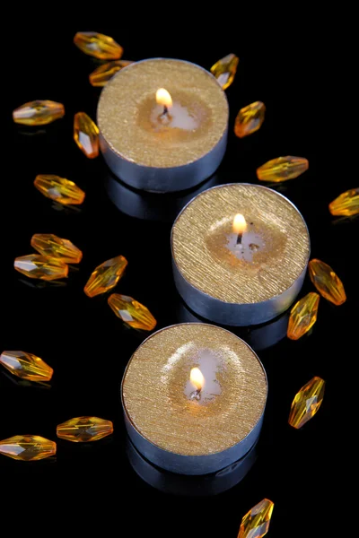 Golden candles isolated on black — Stock Photo, Image