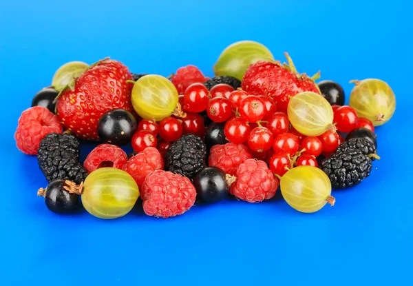 Ripe berries on blue background — Stock Photo, Image