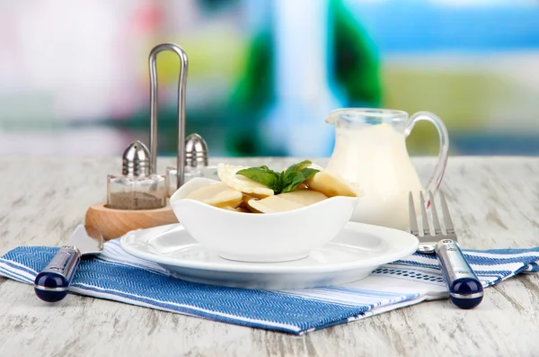 Tasty dumplings on white plate, on bright background — Stock Photo, Image