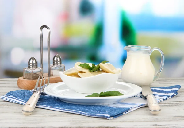 Tasty dumplings on white plate, on bright background — Stock Photo, Image