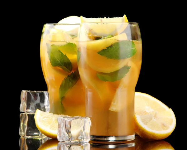Холодный чай с лимоном и мятой на черном фоне — стоковое фото