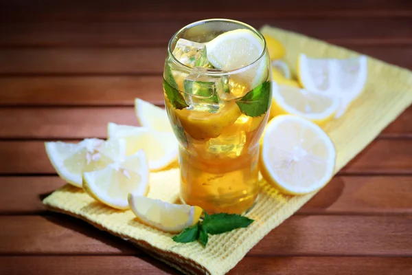 Iced tea with lemon and mint on wooden table — Stock Photo, Image