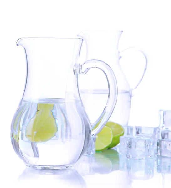Glass pitchers of water with ice and lime isolated on white — Stock Photo, Image