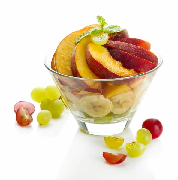 Tasty fruit salad in glass bowl, isolated on white — Stock Photo, Image