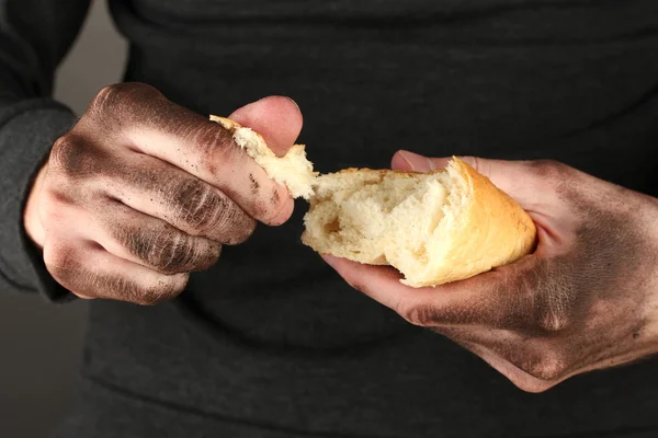 Homeless man holding a white bread, close-up — Stock Photo, Image