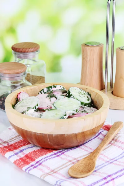 Витаминный овощной салат в деревянной чаше на деревянном столе на естественном фоне — стоковое фото
