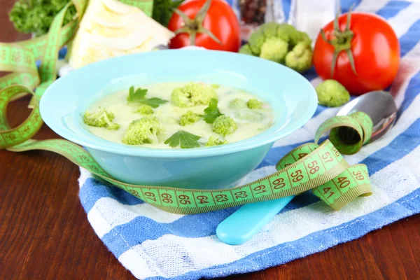 Cabbage soup in plates on napkin on wooden table — Stock Photo, Image