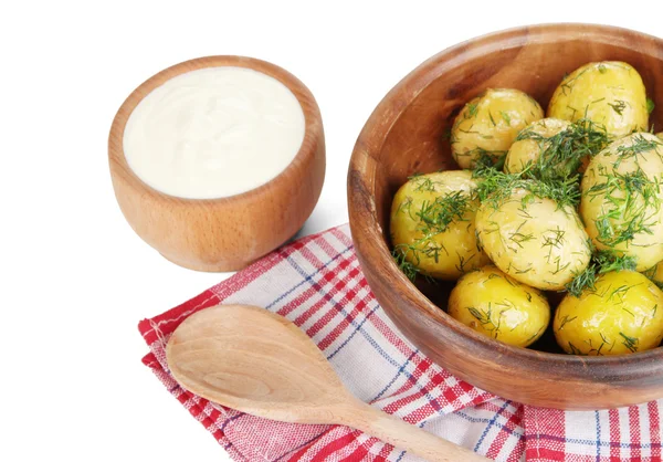 Boiled potatoes on wooden bowl on napkins isolated on white — Stock Photo, Image