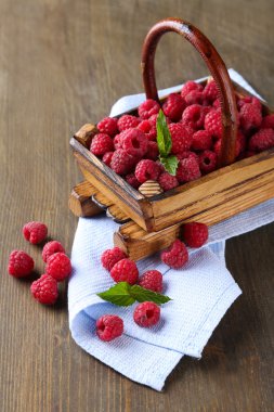 Olgun tatlı ahududu ahşap zemin üzerinde sepeti