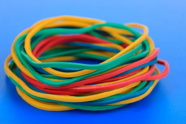 Kleurrijke rubber bands op blauwe achtergrond — Stockfoto