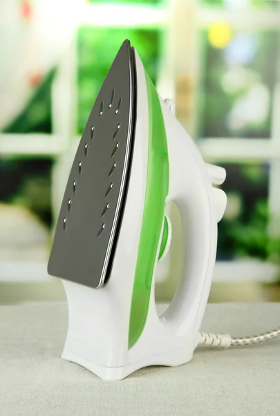 Steam iron on bright background — Stock Photo, Image