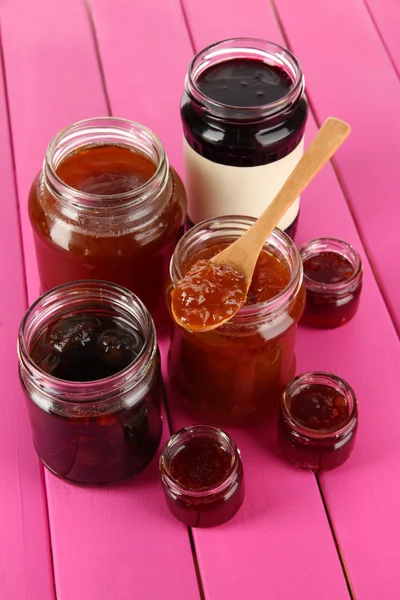 Tasty jam in banks on table — Stock Photo, Image