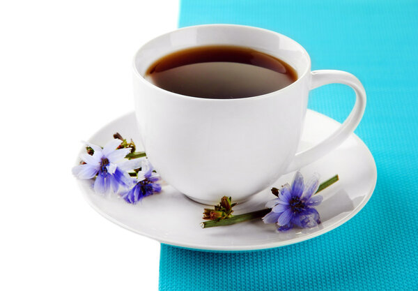 Cup of tea with chicory, isolated on white
