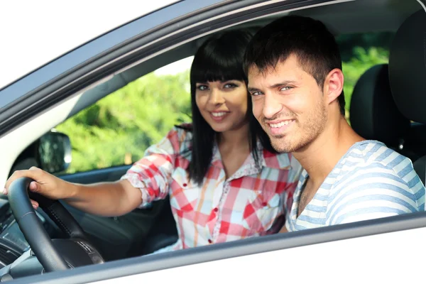 Beautiful happy young couple driving car — Stock Photo, Image